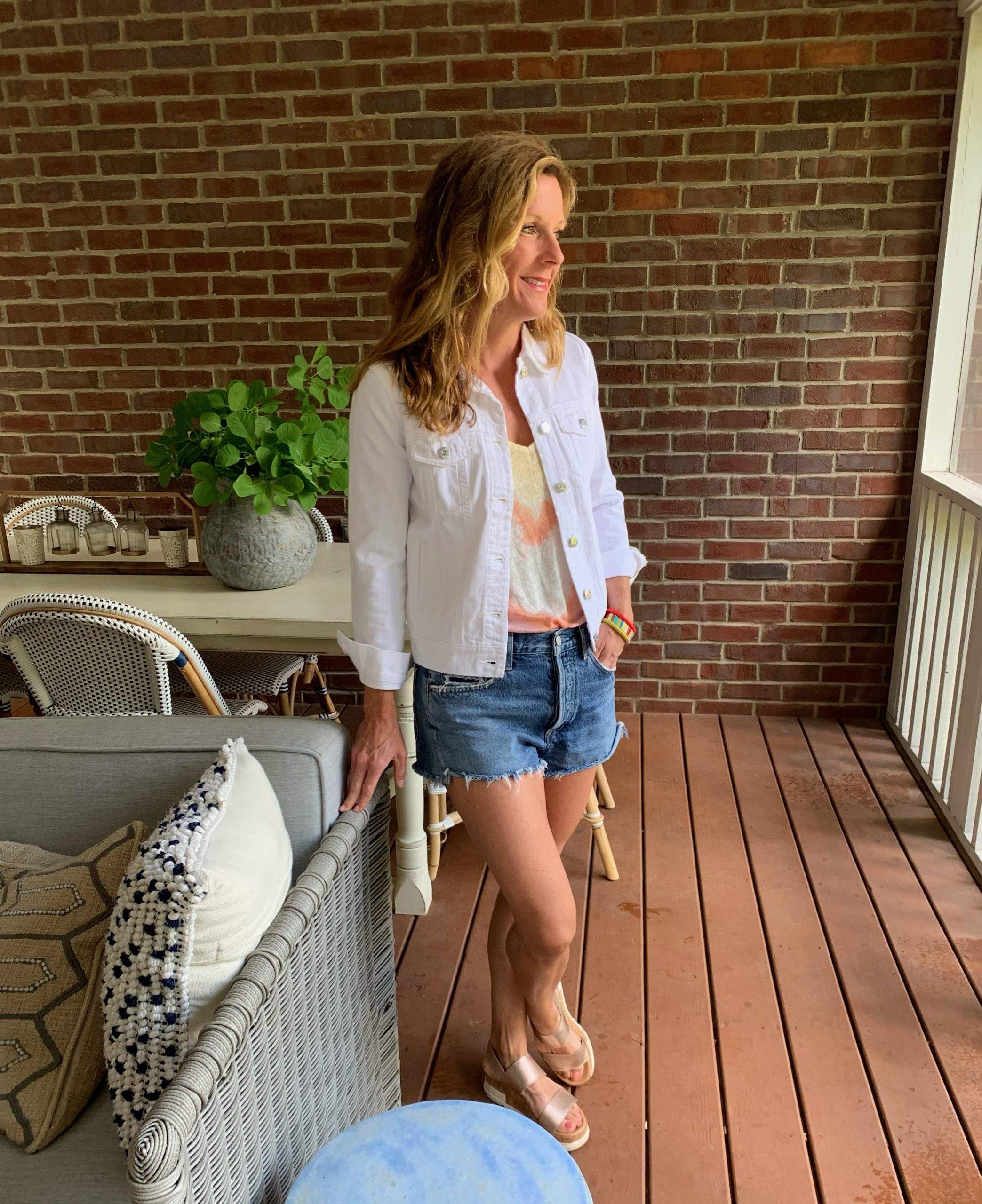 Styling a White Denim Jacket with Distressed Denim Shorts