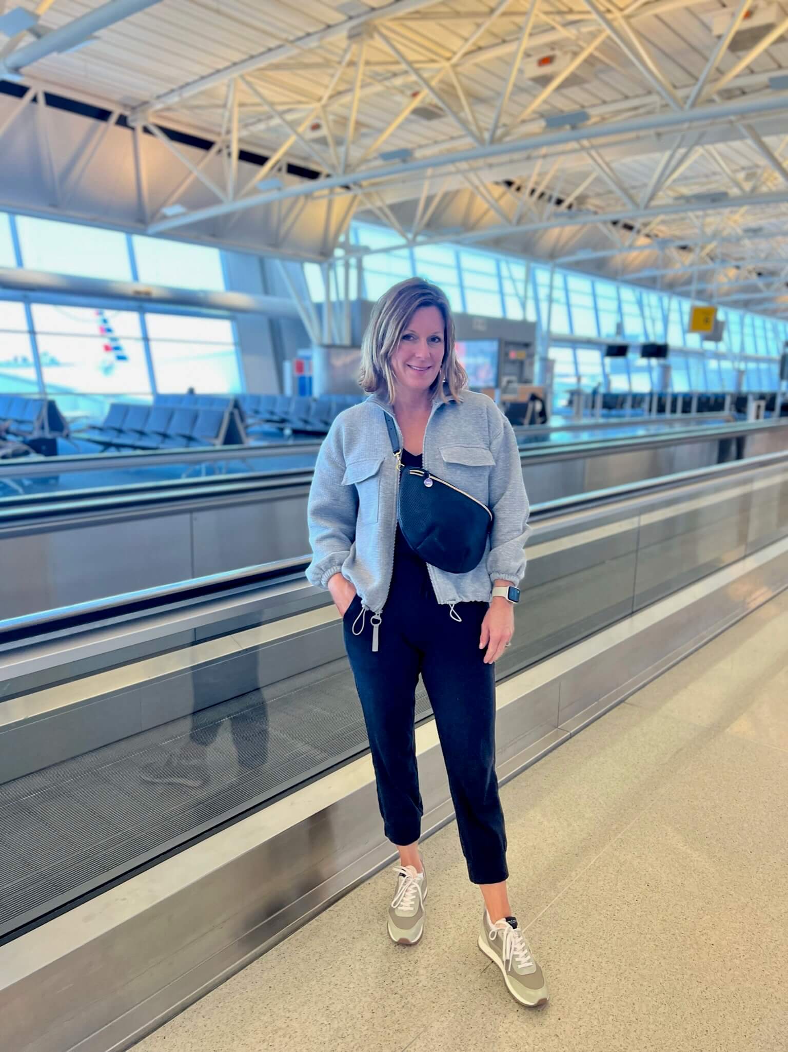 How To Pack For A European Vacation Grey Pullover & Casual Black Tank & Black Joggers what to wear for airplane travel what to wear on an overnight flight how to look put together and comfortable for summer travel how to layer for airplane travel this summer