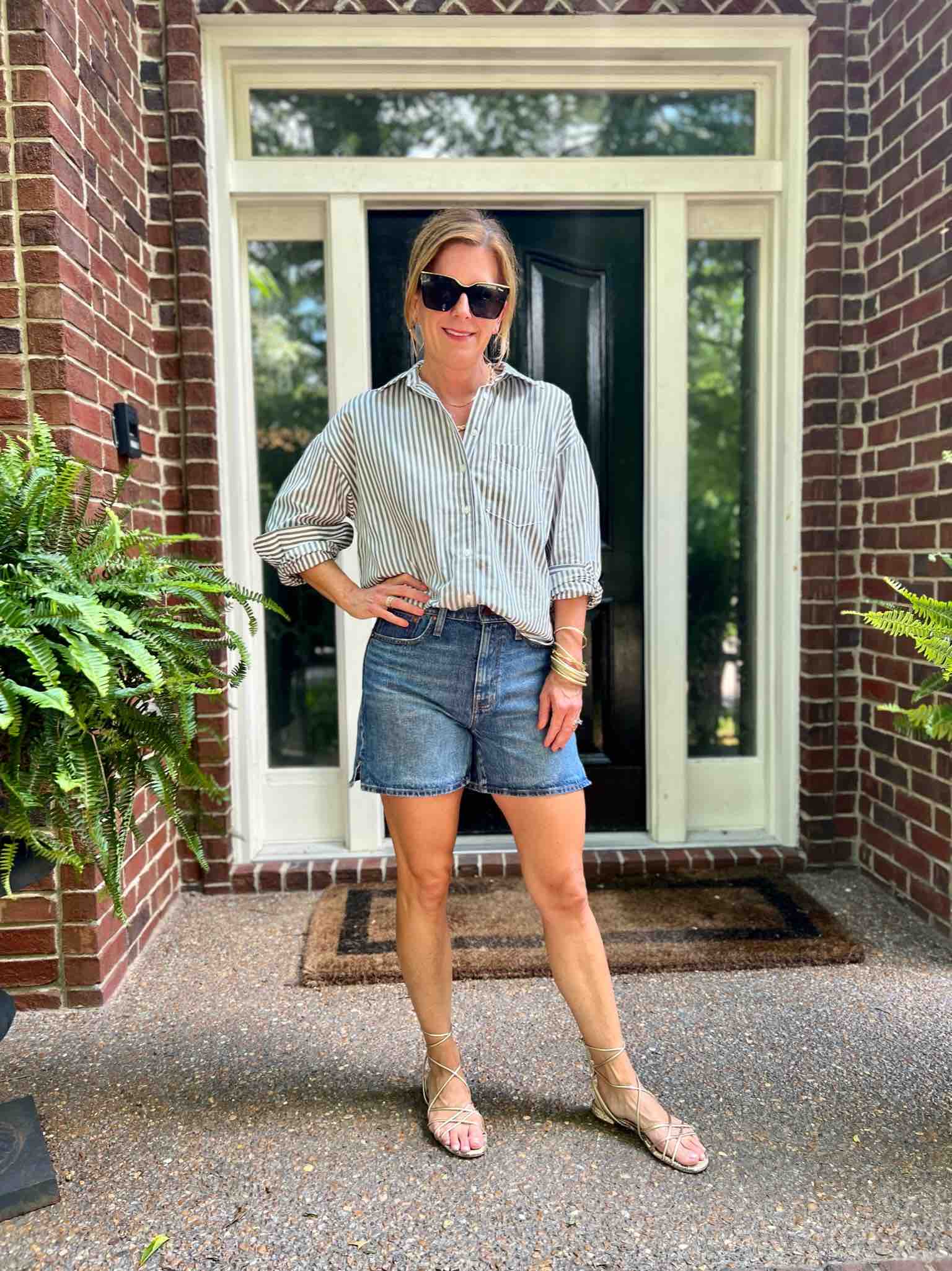 How To Dress For Fall When It's Still Hot Striped Button-Up Shirt & Jean Shorts how to wear cutoffs in your 40s the best denim shorts how to style longer jean shorts Nashville stylists share fun fall looks how to wear a blouse with jean shorts